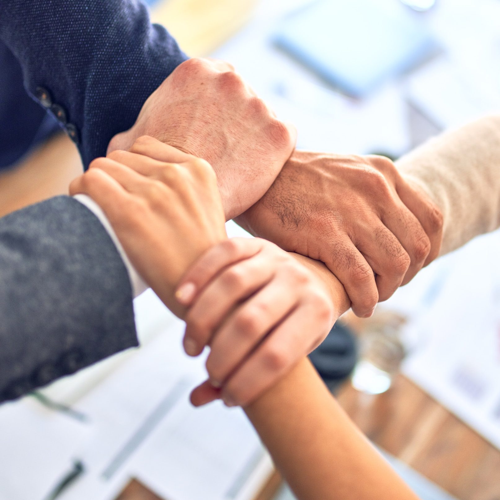 person in black long sleeve shirt holding persons hand